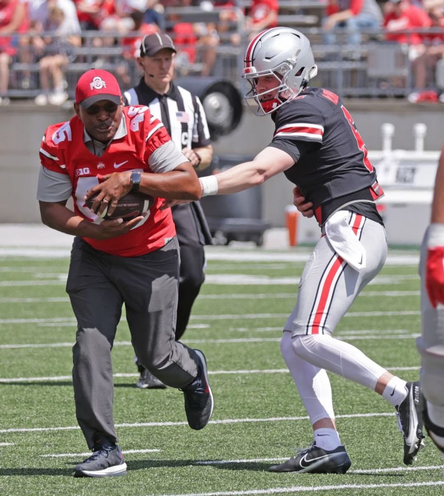 Ohio State football QB Kyle McCord hands ball off to Archie Griffin | Image Credit: David Petkiewicz, Cleveland.com