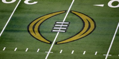 FILE - The College Football Playoff logo is shown on the field at AT&T Stadium before the Rose Bowl NCAA college football game between Notre Dame and Alabama in Arlington, Texas, Jan. 1, 2021. The College Football Playoff announced Thursday, Dec. 1, 2022, it will expand to a 12-team event, starting in 2024, finally completing an 18-month process that was fraught with delays and disagreements. The announcement comes a day after the Rose Bowl agreed to amend its contract for the 2024 and '25 seasons, the last hurdle CFP officials needed cleared to triple the size of what is now a four-team format. (AP Photo/Roger Steinman, File)
