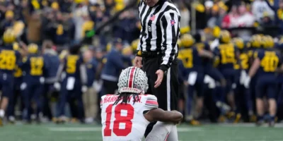 An official offers Ohio State receiver Marvin Harrison Jr. a hand during the second half of Saturday's loss at Michigan. Barbara J. Perenic/Columbus Dispatch