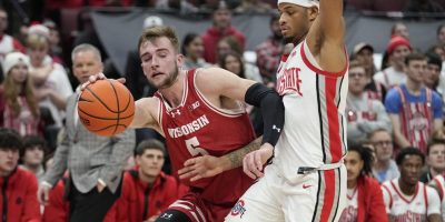 Wisconsin forward Tyler Wahl, left, drives around Ohio State guard Roddy Gayle Jr. during the first half of an NCAA college basketball game Wednesday, Jan. 10, 2024, in Columbus, Ohio. (AP Photo/Sue Ogrocki)