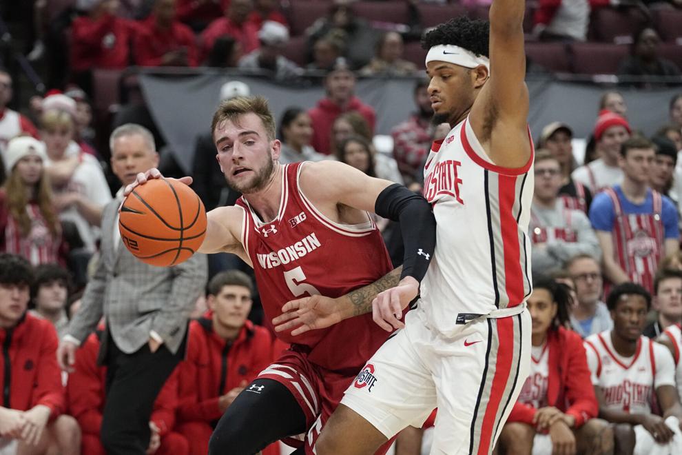 Wisconsin forward Tyler Wahl, left, drives around Ohio State guard Roddy Gayle Jr. during the first half of an NCAA college basketball game Wednesday, Jan. 10, 2024, in Columbus, Ohio. (AP Photo/Sue Ogrocki)