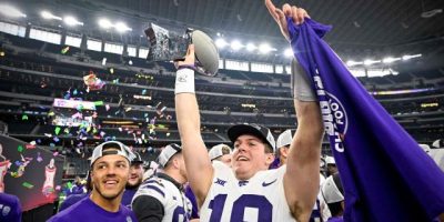 Kansas State quarterback Will Howard (18) holds up the 2022 Big 12 championship trophy after the Wildcats beat TCU in overtime at AT&T Stadium. Image Credit: Yahoo Sports