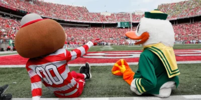 Ohio State mascot Brutus Buckeye with the Oregon Duck | Image Credit: USA Today