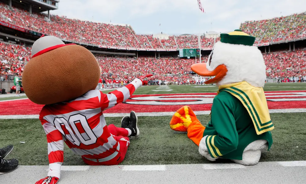 Ohio State mascot Brutus Buckeye with the Oregon Duck | Image Credit: USA Today