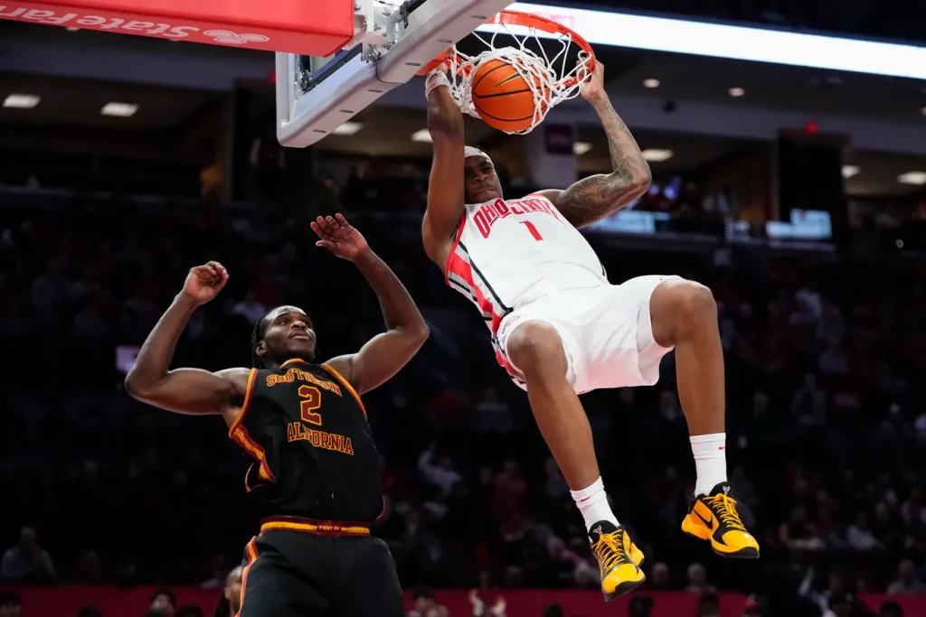 Ohio State Buckeyes forward Amare Bynum (1) dunks over USC Trojans forward Ezra Ausar (2) during the second half of the NCAA men's basketball game at the Schottenstein Center on Feb. 11, 2026. Ohio State won 89-82. Adam Cairns/Columbus Dispatch
