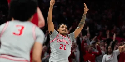 Ohio State Buckeyes forward Devin Royal (21) reacts after making a three point shot against the Wisconsin Badgers in the second half of the NCAA game at Value City Arena on Tuesday, Feb. 17, 2026 in Columbus, Ohio. Samantha Madar/Columbus Dispatch