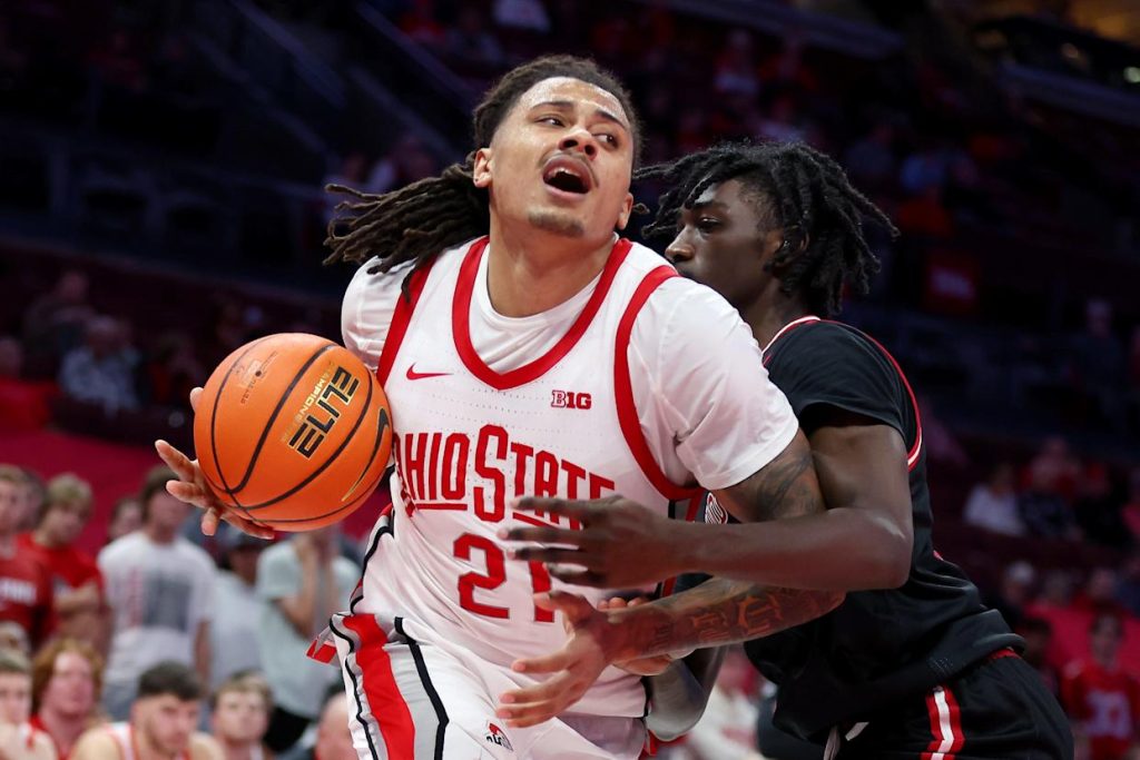 Nov 3, 2025; Columbus, Ohio, USA; Ohio State Buckeyes forward Devin Royal (21) drives against IU Indy Jaguars guard Jaxon Edwards (0) during the second half at Value City Arena. Mandatory Credit: Joseph Maiorana-Imagn Images