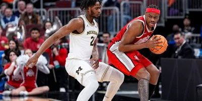 Michigan forward Morez Johnson Jr. (21) defends Ohio State forward Amare Bynum (1) during the second half of Big Ten tournament quarterfinal at United Center in Chicago on Friday, March 13, 2026. | Junfu Han / USA TODAY NETWORK via Imagn Images