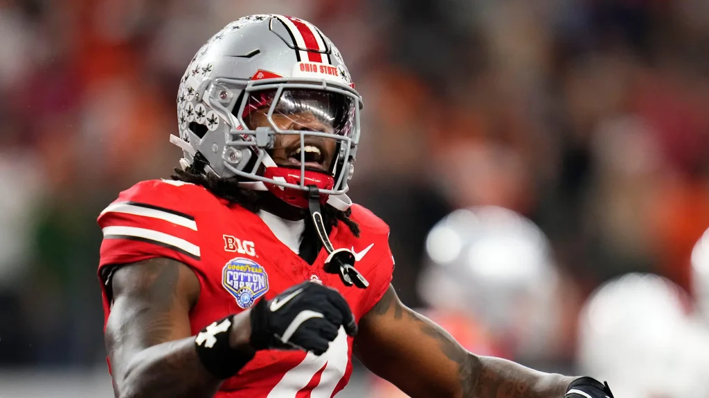 Ohio State Buckeyes wide receiver Jeremiah Smith (4) celebrates a touchdown during the Cotton Bowl at AT&T Stadium in Arlington, Texas for the College Football Playoff quarterfinal game against the Miami Hurricanes on Dec. 31, 2025. Ohio State lost 24-14. | Adam Cairns/Columbus Dispatch / USA TODAY NETWORK via Imagn Images