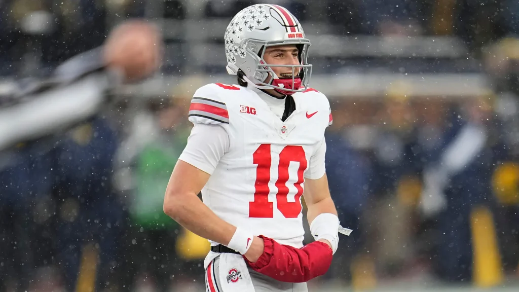 Ohio State Buckeyes quarterback Julian Sayin (10) smiles as he walks off the field following the NCAA football game against the Michigan Wolverines. | Adam Cairns/Columbus Dispatch / USA TODAY NETWORK via Imagn Images