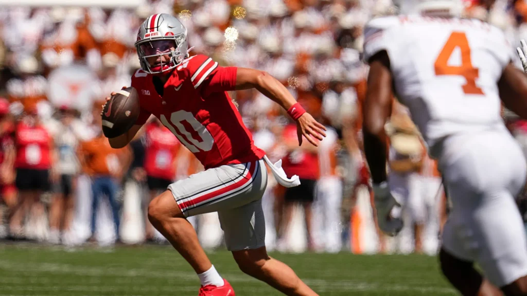 Ohio State Buckeyes quarterback Julian Sayin (10) runs during the first half of the NCAA football game against the Texas Longhorns at Ohio Stadium on Aug. 30, 2025. | Adam Cairns/Columbus Dispatch / USA TODAY NETWORK via Imagn Images