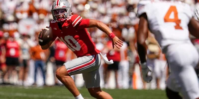 Ohio State Buckeyes quarterback Julian Sayin (10) runs during the first half of the NCAA football game against the Texas Longhorns at Ohio Stadium on Aug. 30, 2025. | Adam Cairns/Columbus Dispatch / USA TODAY NETWORK via Imagn Images