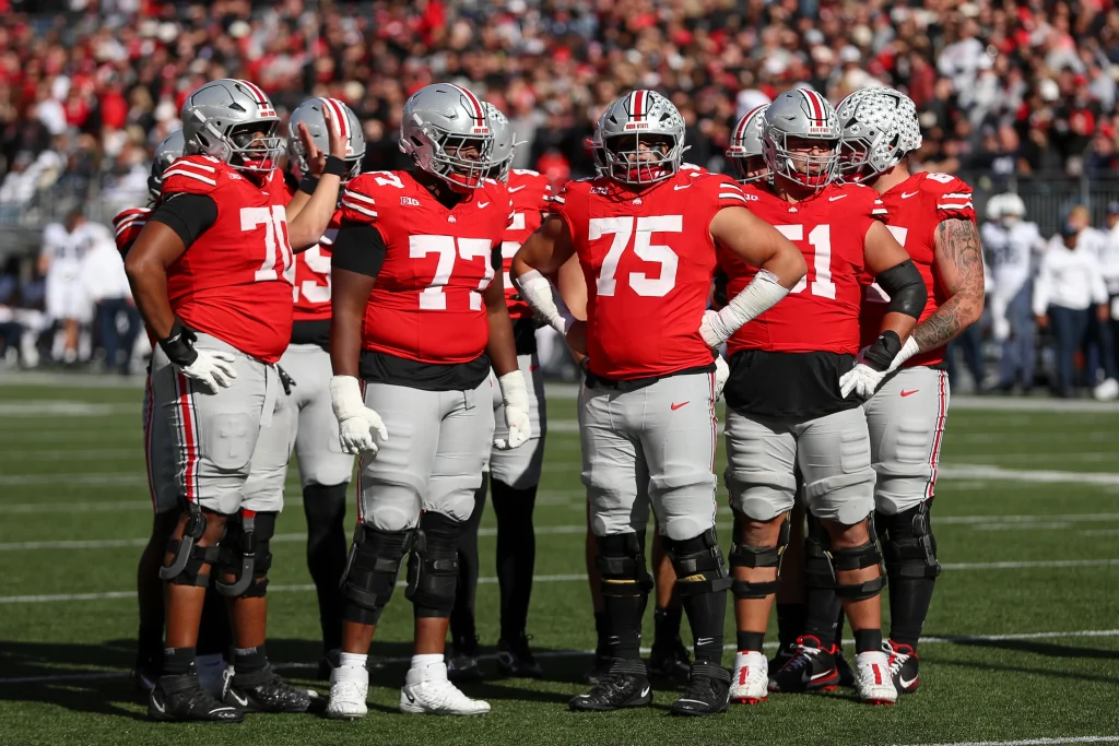 COLUMBUS, OH - NOVEMBER 01: Ohio State Buckeyes offensive lineman Phillip Daniels (70) stands with Tegra Tshabola (77), Carson Hinzman (75), and Luke Montgomery (51) during the game against the Penn State Nittany Lions and the Ohio State Buckeyes on November 1, 2025, at Ohio Stadium in Columbus, OH. (Photo by Ian Johnson/Icon Sportswire via Getty Images) Icon Sportswire via Getty Images