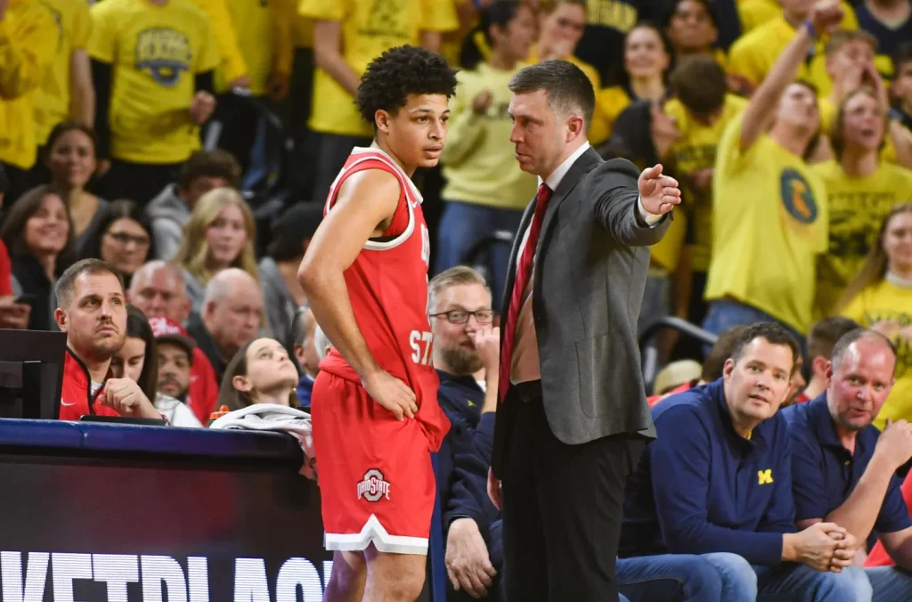 ANN ARBOR, MICHIGAN - JANUARY 23: Head Basketball Coach Jake Diebler (R) of the Ohio State Buckeyes gives instructions to John Mobley Jr. #0 during the second half of a college basketball game against the Michigan Wolverines at Crisler Arena on January 23, 2026 in Ann Arbor, Michigan. The Michigan Wolverines won the game 74-62. (Photo by Aaron J. Thornton/Getty Images) Getty Images