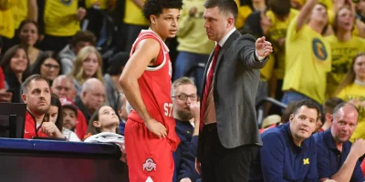 ANN ARBOR, MICHIGAN - JANUARY 23: Head Basketball Coach Jake Diebler (R) of the Ohio State Buckeyes gives instructions to John Mobley Jr. #0 during the second half of a college basketball game against the Michigan Wolverines at Crisler Arena on January 23, 2026 in Ann Arbor, Michigan. The Michigan Wolverines won the game 74-62. (Photo by Aaron J. Thornton/Getty Images) Getty Images