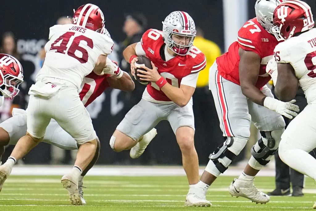 Ohio State Buckeyes quarterback Julian Sayin (10) scrambles during the first half of the Big Ten Conference championship game against the Indiana Hoosiers at Lucas Oil Stadium in Indianapolis on Dec. 6, 2025. Adam Cairns/Columbus Dispatch, Adam Cairns/Columbus Dispatch / USA TODAY