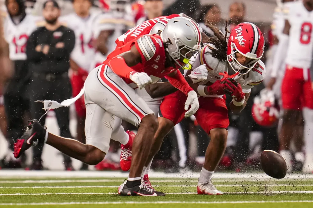 Ohio State Buckeyes cornerback Jermaine Mathews Jr. (7) and defensive back Cam Calhoun (18) hit Maryland Terrapins wide receiver Jayden Kitchens (17) during the NCAA football game at Ohio Stadium in Columbus on Oct. 10, 2026. Adam Cairns/Columbus Dispatch, USA TODAY Network Via Reuters Co