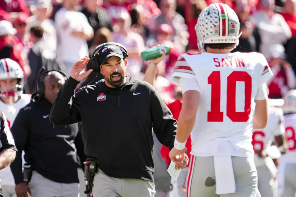 Ohio State Buckeyes head coach Ryan Day talks to Ohio State Buckeyes quarterback Julian Sayin (10) during the NCAA football game against the Indiana Hoosiers at Memorial Stadium Stadium in Bloomington, Ind. on Oct. 17, 2026. Adam Cairns/Columbus Dispatch