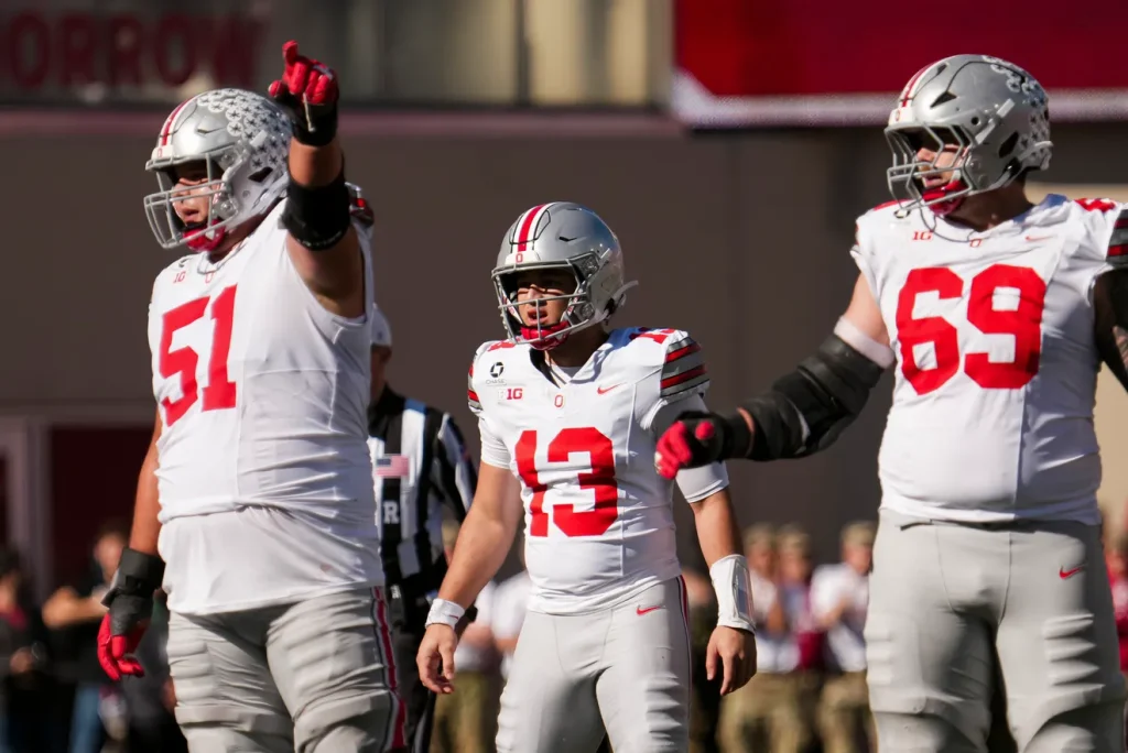 Ohio State Buckeyes quarterback Luke Fahey (13) lines up behind offensive lineman Luke Montgomery (51) and offensive lineman Ian Moore (69) during the NCAA football game against the Indiana Hoosiers at Memorial Stadium Stadium in Bloomington, Ind. on Oct. 17, 2026. Adam Cairns/Columbus Dispatch